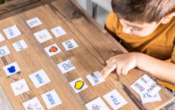 Little kid playing with cards of words and pictures. Time to learn. Education concept.